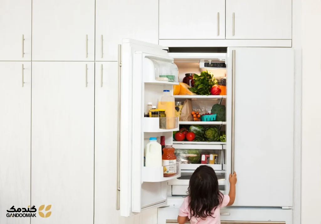 هرگز نباید روی یخچال نگهداری؛ دستی که سیب را از کاسه میوه برمیدارد
