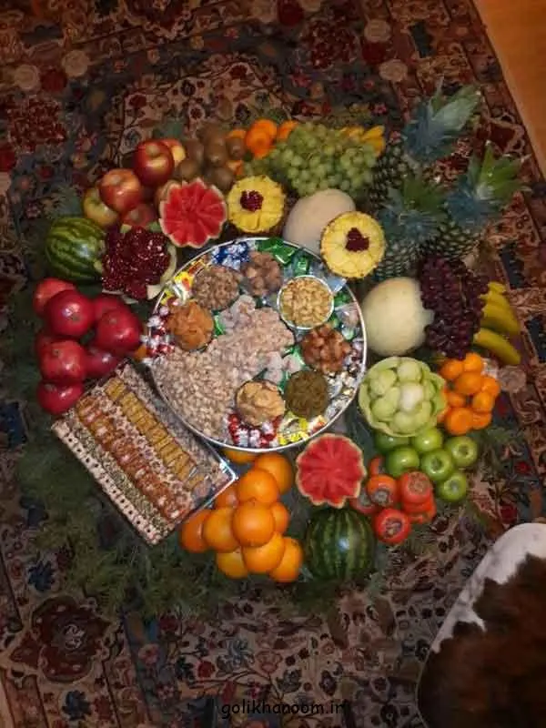 گلآرایی و شمعهای قرمز و سبز در سفره یلدا