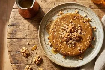 گردوی تازه خردشده در کاسه برای تهیه حلوای گردو و عسل