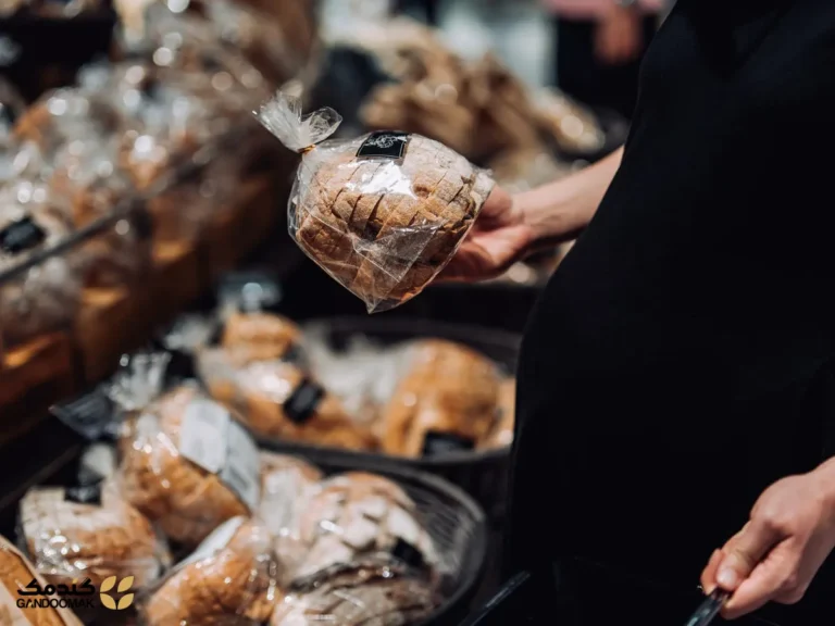 روش‌های موثر برای نگهداری نان؛ یک زن باردار در حال خرید نان تازه در س